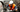 Factory worker in safety vest and hard hat operating heavy machinery in a manufacturing plant