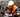 Factory worker in safety vest and hard hat operating heavy machinery in a manufacturing plant
