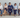 Job applicants sitting in a row with resumes during a staffing agency interview process
