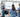 Healthcare team of doctors and nurses reviewing patient data on large digital monitors in a hospital setting